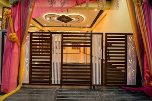 A gated entrance with a decorative ceiling and a staircase leading inside.