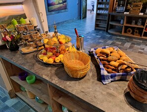 A buffet setup with various food items and decorative elements.