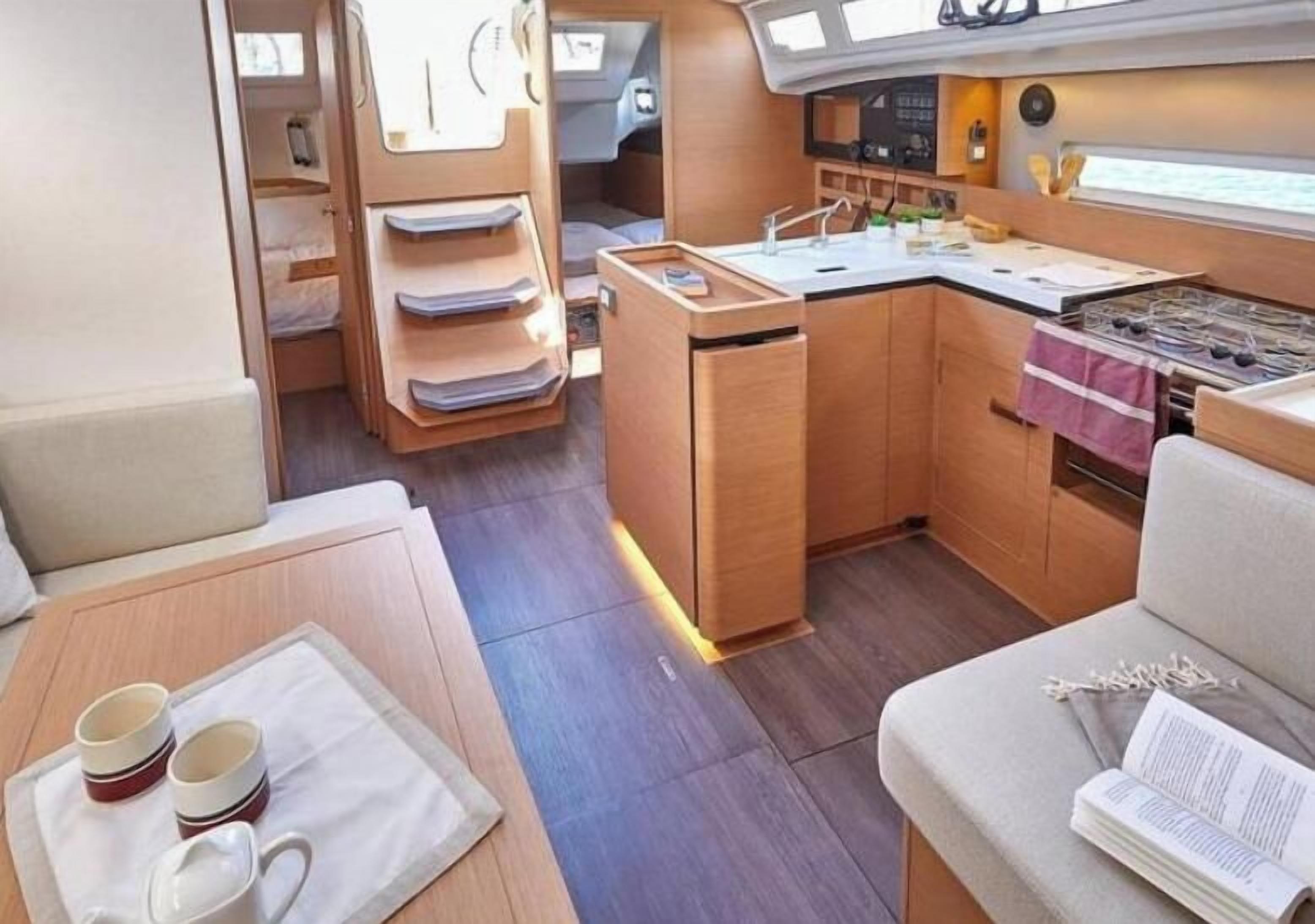 A compact kitchen with a stove, sink, and storage cabinets.