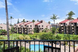 A hotel with multiple buildings, a swimming pool, and palm trees. - Top-Floor With Views I Kamaole Sands 6410 (Kihei)
