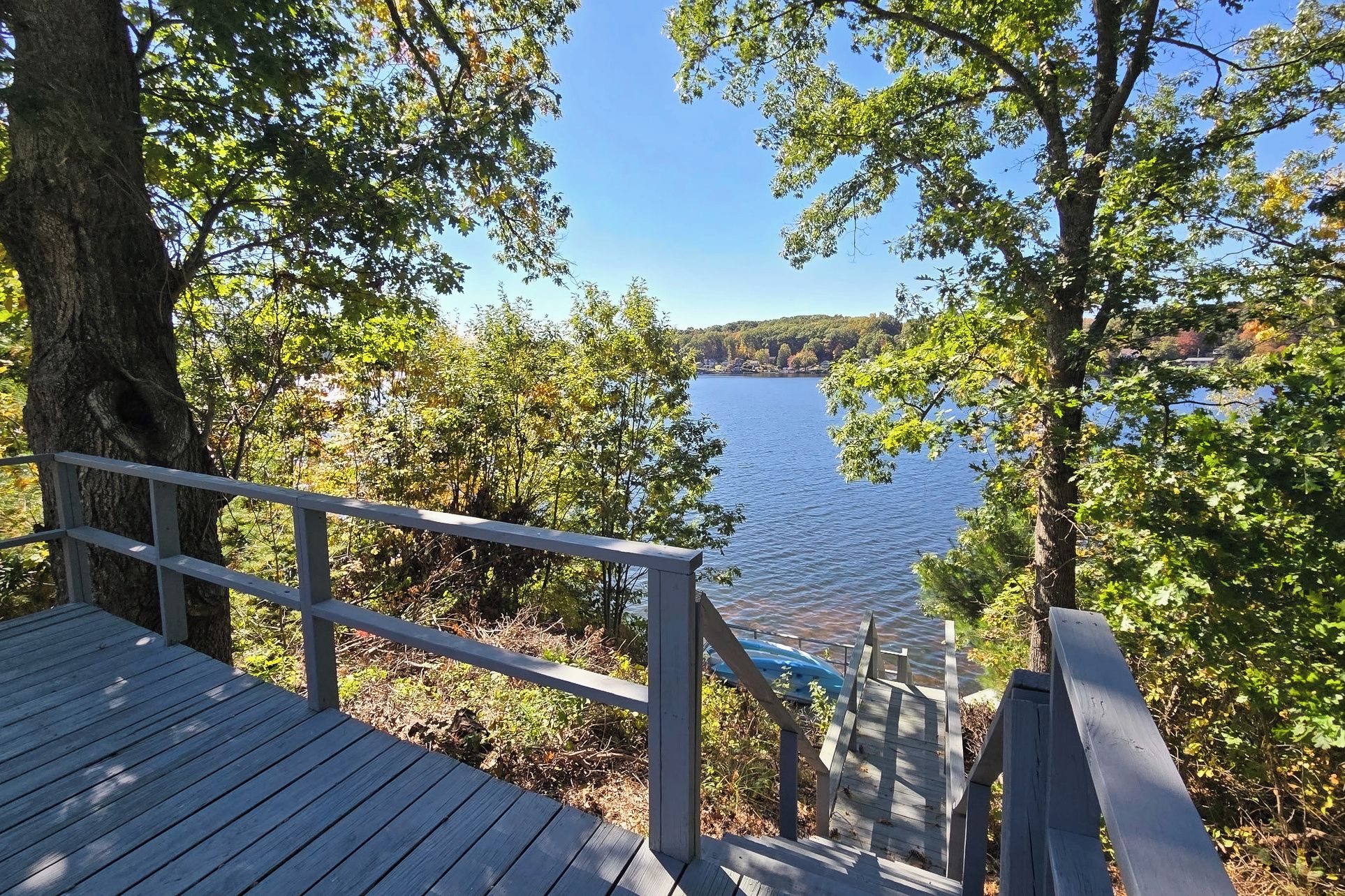 Mid-level deck with kayaks and lake below.