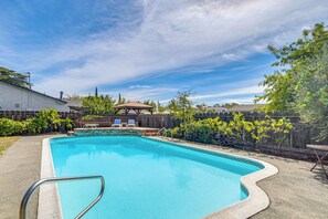 A swimming pool with a wooden deck, lounge chairs, and a covered seating area. - Orland Home w/ Pool! Near Park, Tennis & Dtwn (Orland)