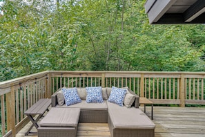 A wooden deck with a built-in sofa and a table. - Great for Groups! Wilmington Gem w/ Game Room (Wilmington)