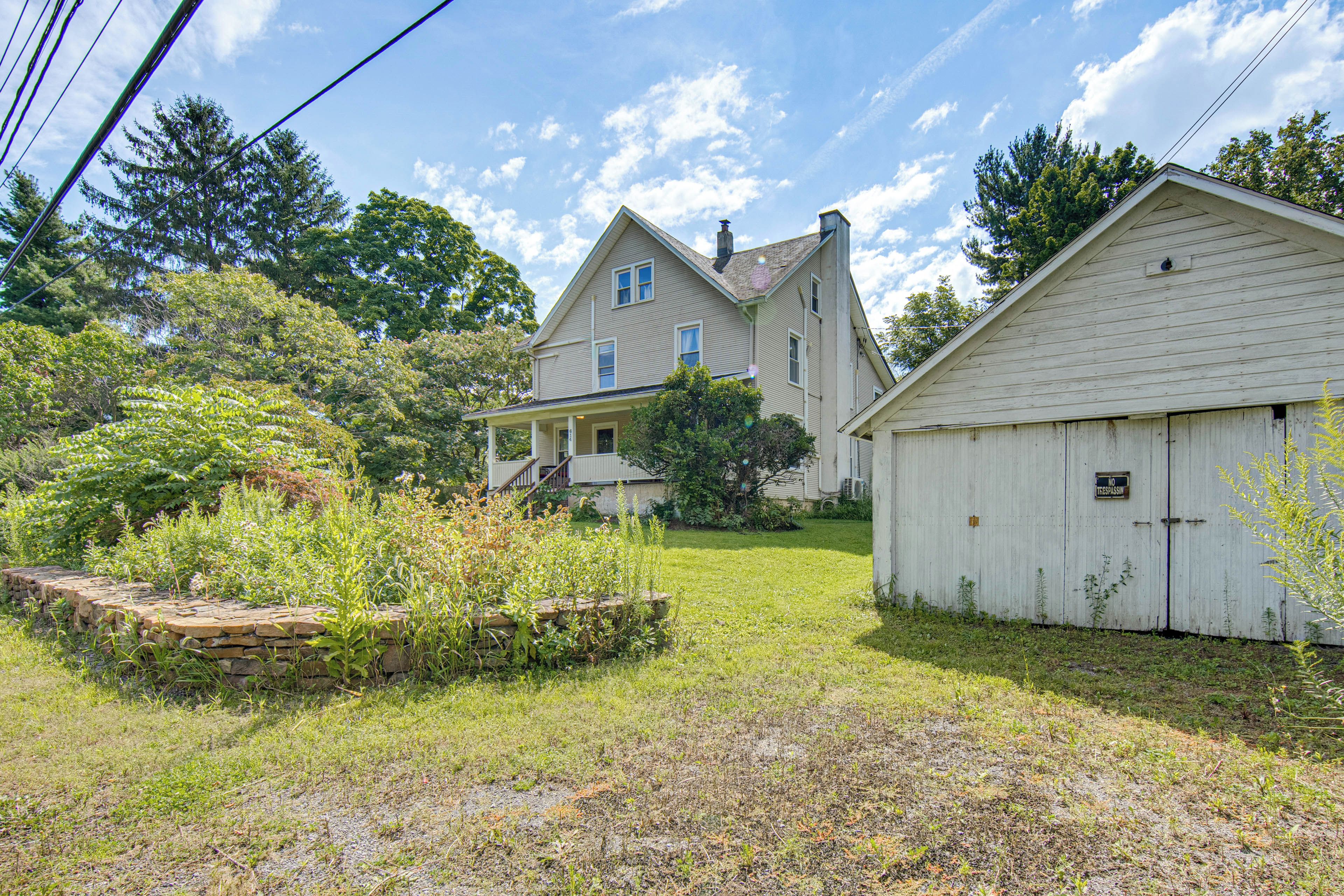 A two-story house with a front porch and a garage.