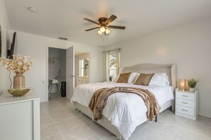 A bedroom with a bed, bedside table, and a ceiling fan. - 13 Mi to Beach! Family Getaway in Port St Lucie (Port Saint Lucie)