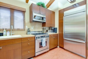 A kitchen with wooden cabinets, a stainless steel refrigerator, a microwave, a stove, and a sink. - 2 Mi to Sun Valley Resort! Upscale Mtn-view Home (Ketchum)