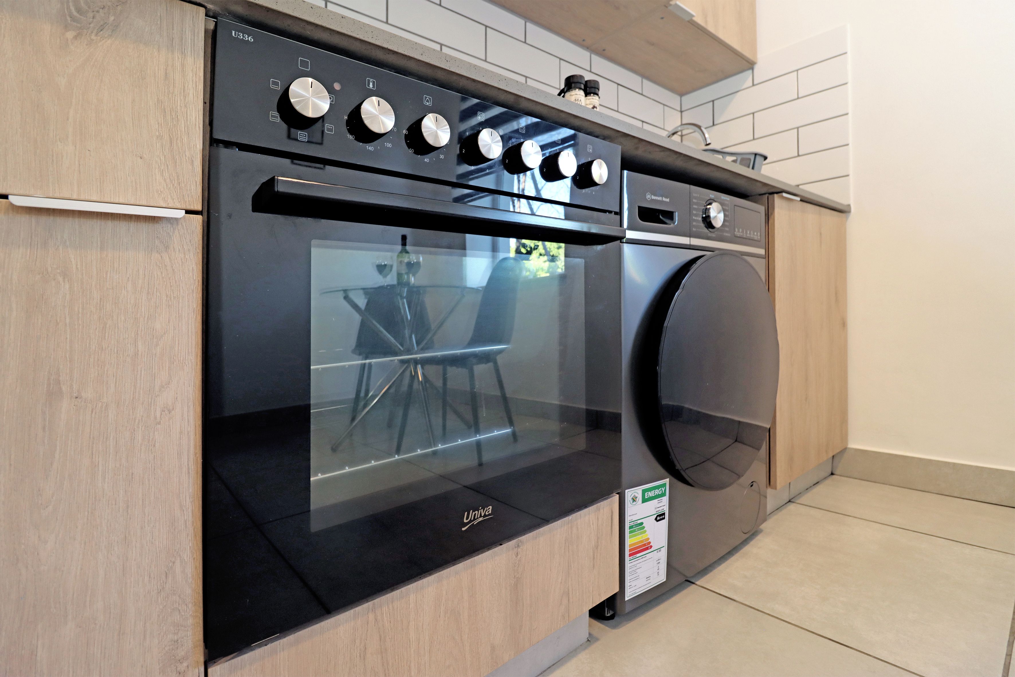 A modern kitchen with a built-in oven and a dishwasher.