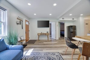 A modern living room with a sofa, a coffee table, and a TV mounted on the wall. - Poconos Mtn Getaway: 4 Mi to Camelback Resort (Tannersville)