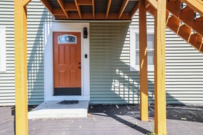 A wooden porch with a door, a window, and a small step leading to the entrance. - Poconos Mtn Getaway: 4 Mi to Camelback Resort (Tannersville)