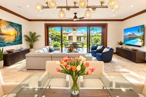 A spacious living room with a large TV, comfortable seating, a glass coffee table, and a view of the outdoors. - Wailea Beach Villas with Private Plunge Pool | 3 BR Sleeps 8 | Car Incl. w/ 6+ Nights | WBV-G101 by KBM (Wailea)