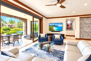 A modern living room with a glass coffee table, blue sofas, and a large flat-screen TV. - Wailea Beach Villas with Private Plunge Pool | 3 BR Sleeps 8 | Car Incl. w/ 6+ Nights | WBV-G101 by KBM (Wailea)