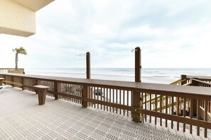 A wooden deck with a railing overlooking the ocean. - 3 BR Oceanfront Condo with Two Shared Pools and a Hot Tub! Atalaya Towers #703 (Garden City)