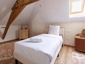 A bedroom with a bed, a nightstand, a dresser, and a window. - Duplex with Spa & Sauna - 4 guests (LA SENTINELLE)