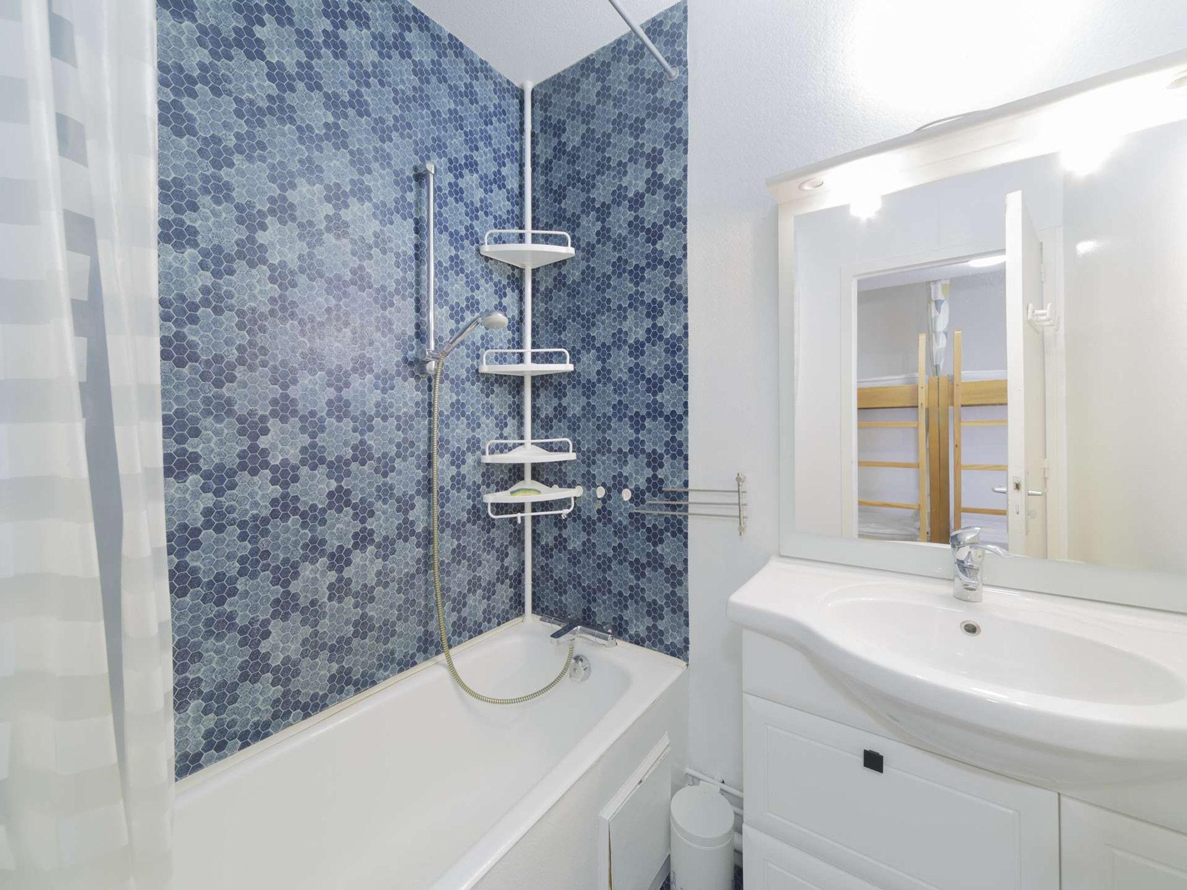 A bathroom with a bathtub, a shower, and a sink.