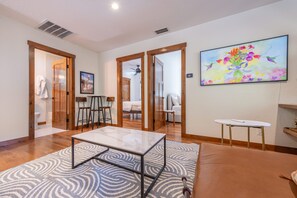 A modern living room with a marble coffee table, a patterned rug, and a painting on the wall. - Tahoe Park Lodge 4 Bedroom Home (Tahoe City)