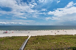 A beach with a wooden boardwalk leading to the shore, sandy beach, and the ocean. - Beautiful 3 bedroom/ 3 bath condo located on the 5th floor in East tower (ORANGE BEACH)