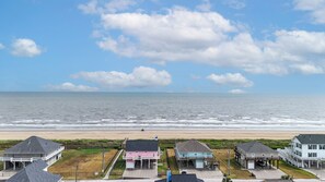 A coastal residential area with houses overlooking the beach and ocean. - Sweet Escape: 2  BR, 2.5  BA House in Crystal Beach, Sleeps 7 (Crystal Beach)