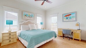 A bedroom with a bed, bedside tables, a desk, and a ceiling fan. - Sweet Escape: 2  BR, 2.5  BA House in Crystal Beach, Sleeps 7 (Crystal Beach)