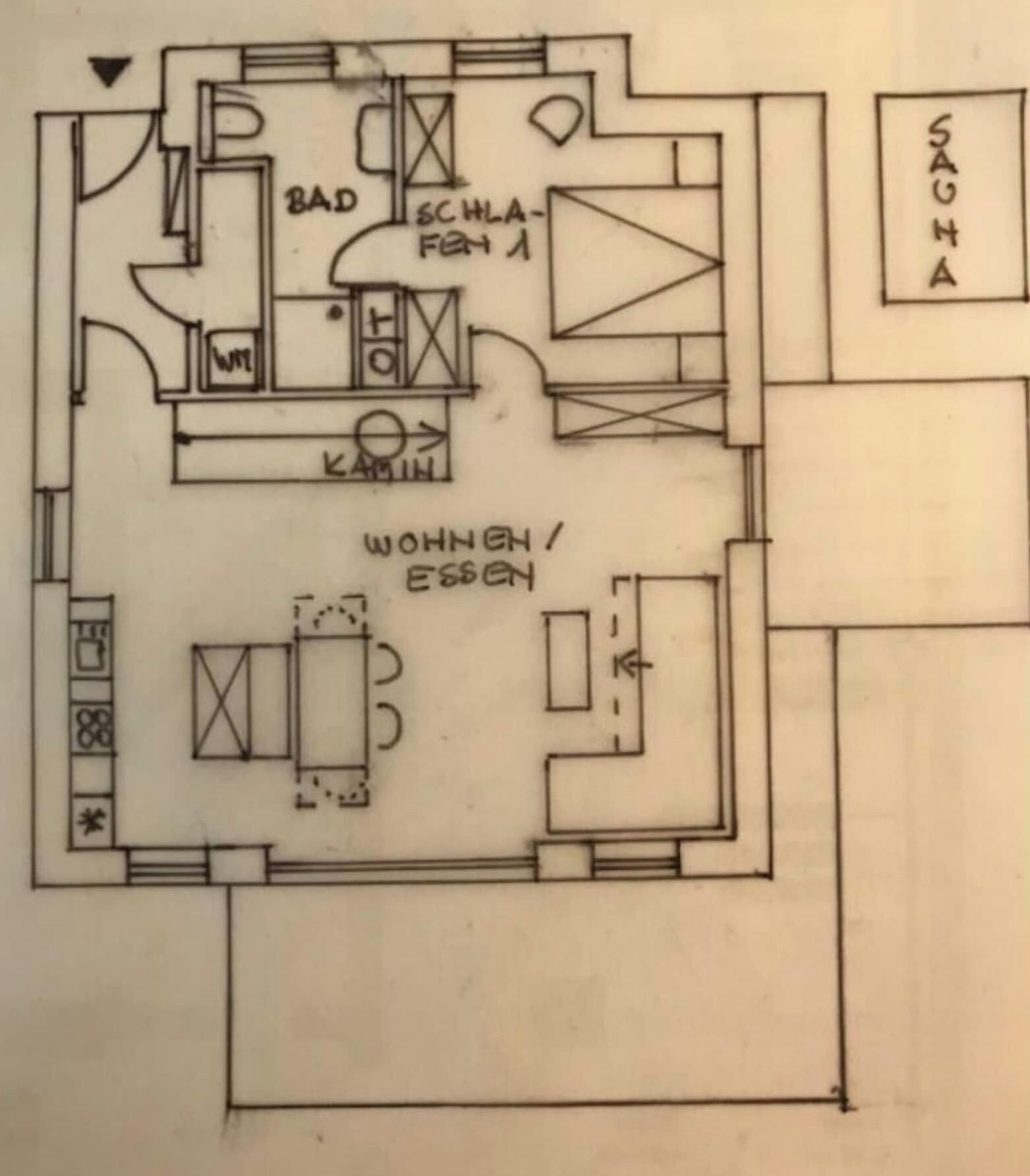 Ein Grundriss mit beschrifteten Räumen, darunter eine Küche, ein Badezimmer und ein Wohnbereich.