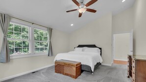 A bedroom with a bed, a ceiling fan, a window with curtains, and a dresser. - The Harness Creek Retreat in Annapolis (Annapolis)