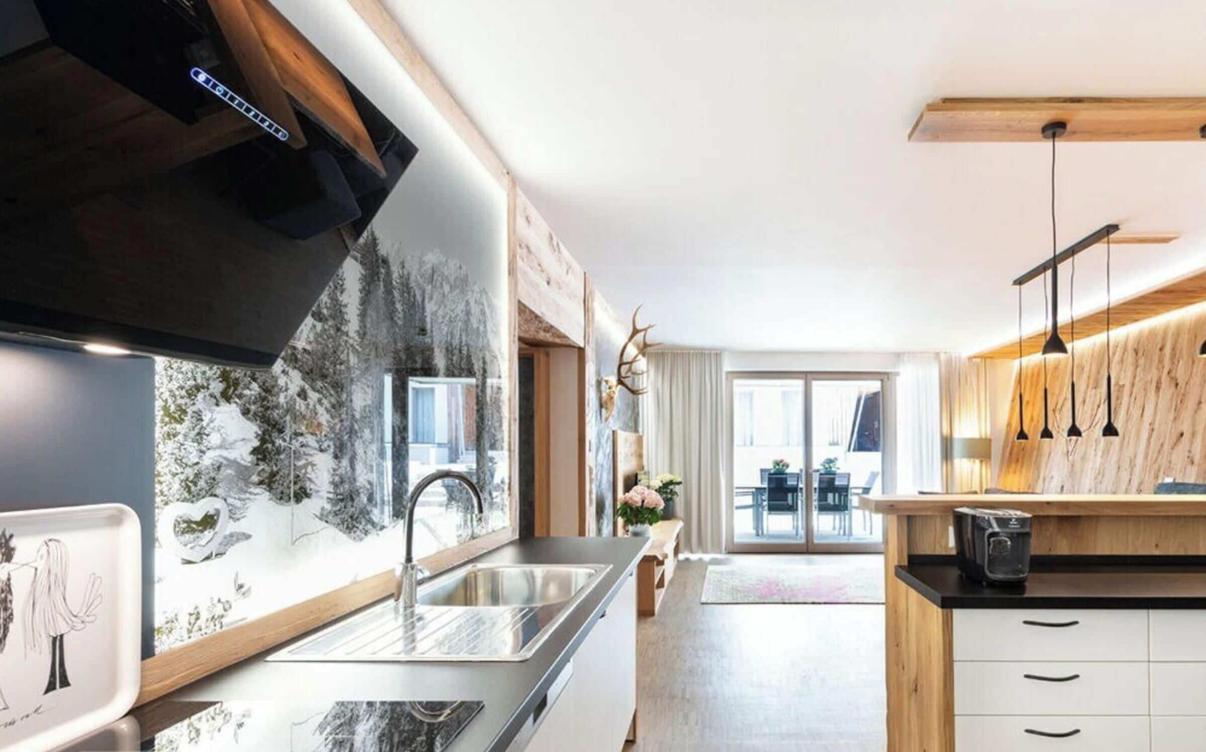 A modern kitchen with a large window, a built-in microwave, and a wooden countertop.