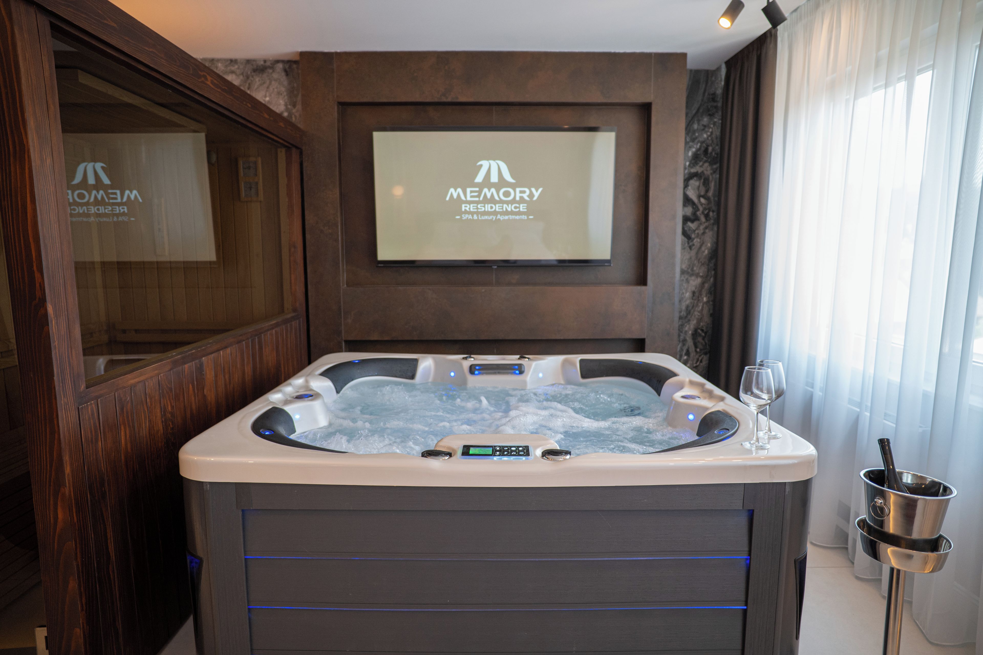 Une salle de bain moderne avec une baignoire à jets, un panneau de commande numérique et un panneau décoratif encadré placé au-dessus de la baignoire.