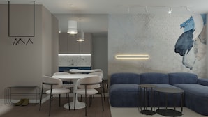 A modern living room with a dining area, a blue sofa, and a minimalist design. - Memory Residence Spa & Luxury Apartments (Banja Luka)