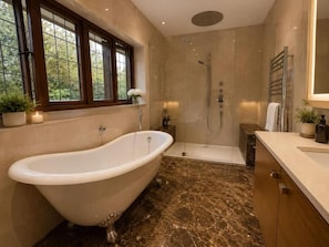 A bathroom with a freestanding bathtub, a walk-in shower, and a vanity with a mirror. - Brook House (Stoke Poges)