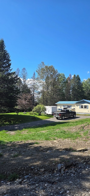 A residential area with a house, a truck, and a trailer.