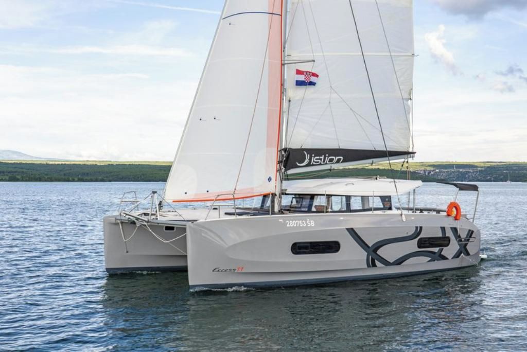 A sailboat with a Croatian flag, named 'Eclipse 11,' on a body of water.