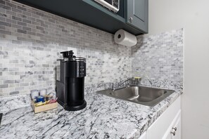 A kitchen with a marble countertop, a stainless steel sink, and a coffee maker. -  Your cozy little getaway in Tampa! Enjoy a private studio in a perfect location (Tampa)