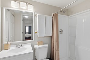 A bathroom with a white sink, mirror, and toilet. -  Your cozy little getaway in Tampa! Enjoy a private studio in a perfect location (Tampa)