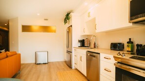A modern kitchen with white cabinets, stainless steel appliances, and a built-in oven. - Free Parking Historic 1BR plus Den DT Halifax (Halifax)