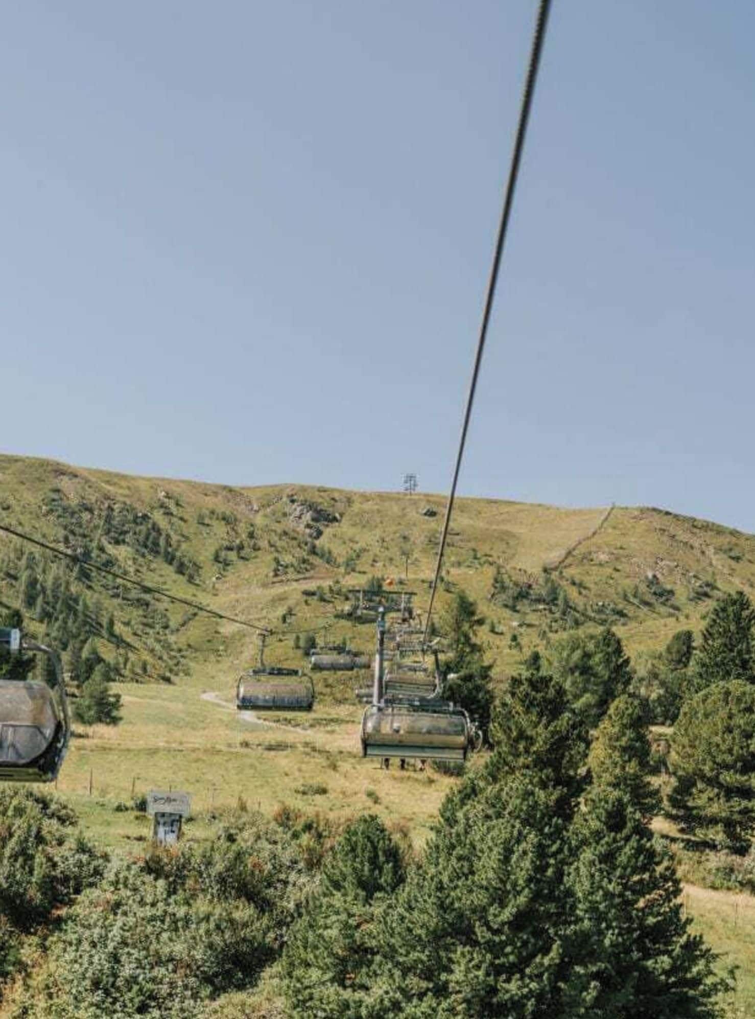 A cable car system on a hillside with a clear sky.