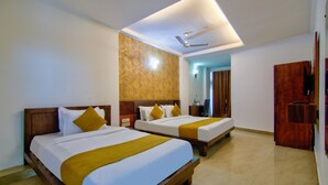 A hotel room with two beds, a ceiling fan, and a minibar. - HOTEL JAD STAR RESIDENCY (New Delhi)