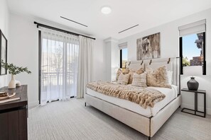 A bedroom with a bed, a bedside table, a lamp, a window with curtains, and a painting on the wall. - Frontgate 229 - 4 Bedroom Residence (Avon)