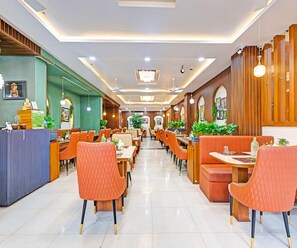 A spacious restaurant with high ceilings, modern lighting, and a clean, organized layout. - Classic Hotel U Turn & Restaurant (Dr. Ambedkar Nagar)