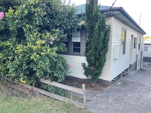 A single-story house with a front porch, a small tree, and a wooden fence. - Comfortable 3 bedroom house in Wallsend (Wallsend)