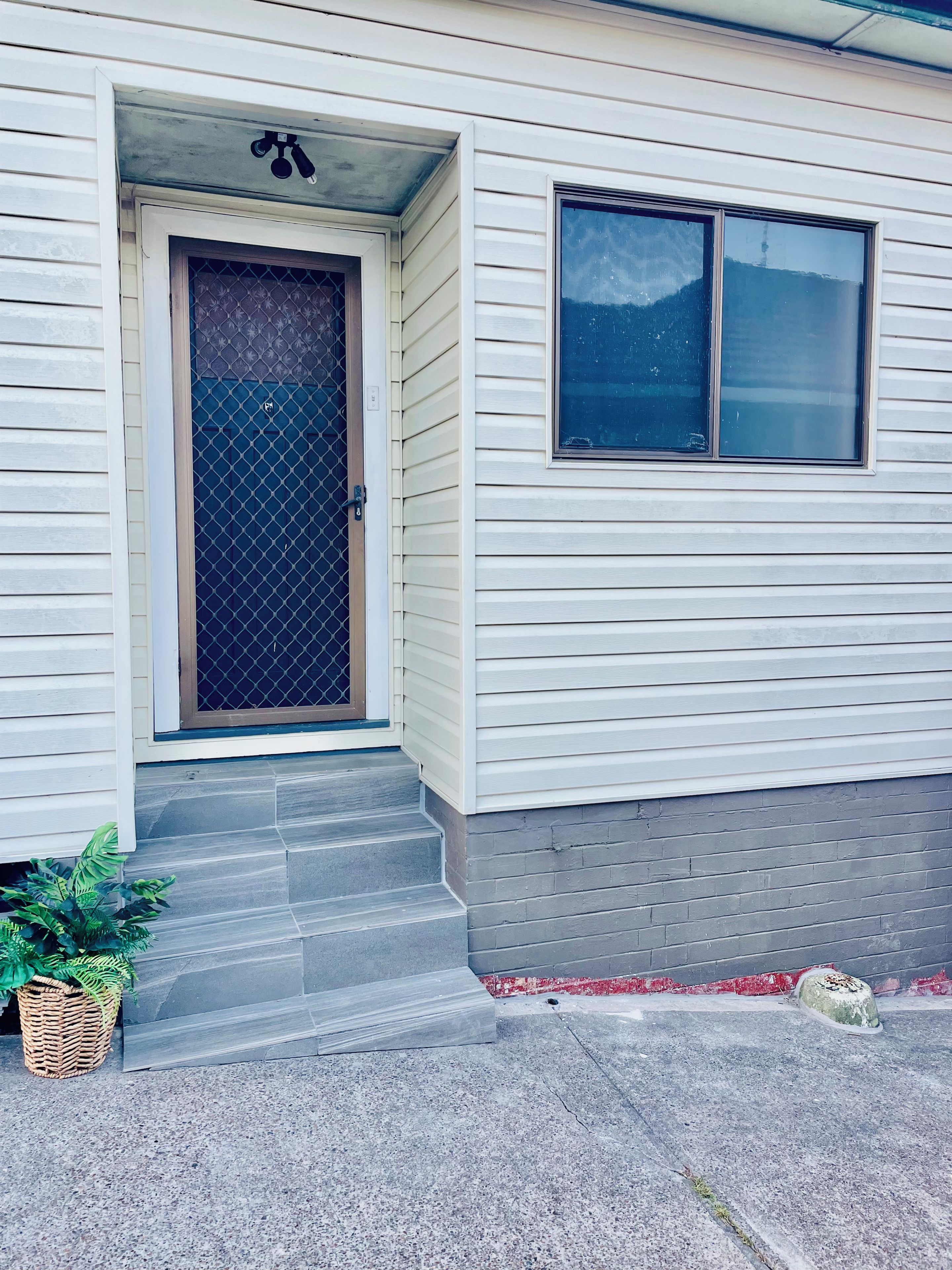A house with a front door, a window, and a small porch.