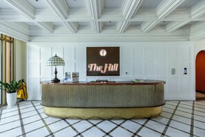 A reception area with a check-in counter, a potted plant, and a sign reading "Sun Grand City Hillside Residence The Hill". - The Clound Apartment Hillside Phu Quoc (Phu Quoc)