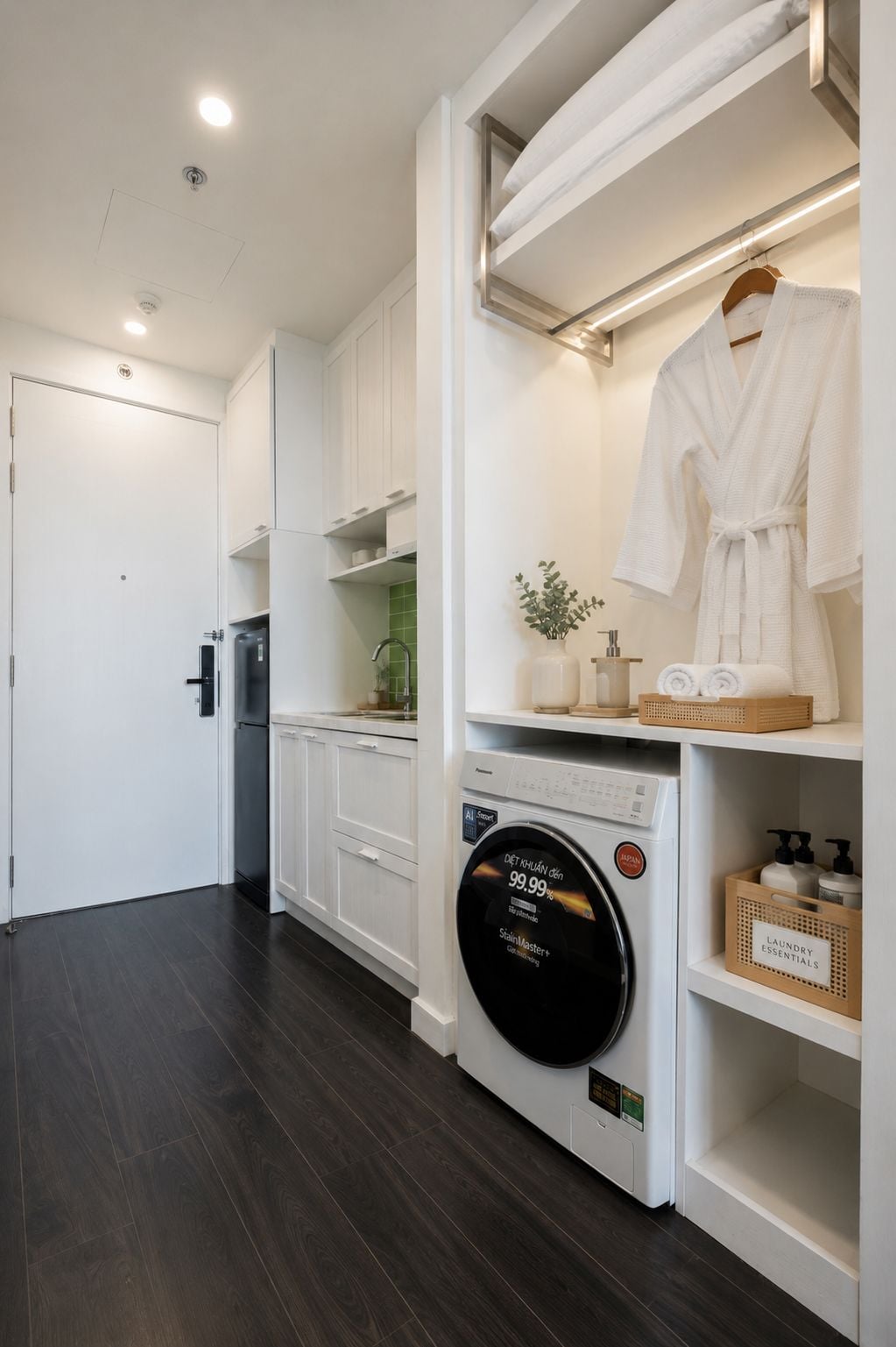 A modern laundry room with a front-loading washing machine, a drying rack, and shelves with laundry essentials.