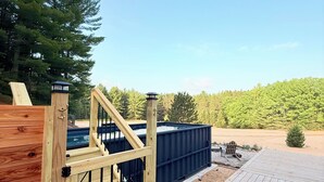A wooden deck with a pool, a wooden gate, and a sign indicating no diving. - Romantic Escape with Private Heated Pool & Sauna (Fife Lake)