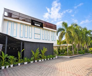 A modern townhouse with a sign indicating it is serviced by OYO. - Deluxe Room Hotel U Turn & Restaurant (Dr. Ambedkar Nagar)