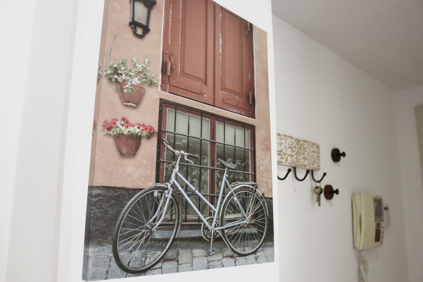 A wall with a door, a window, and a telephone.
