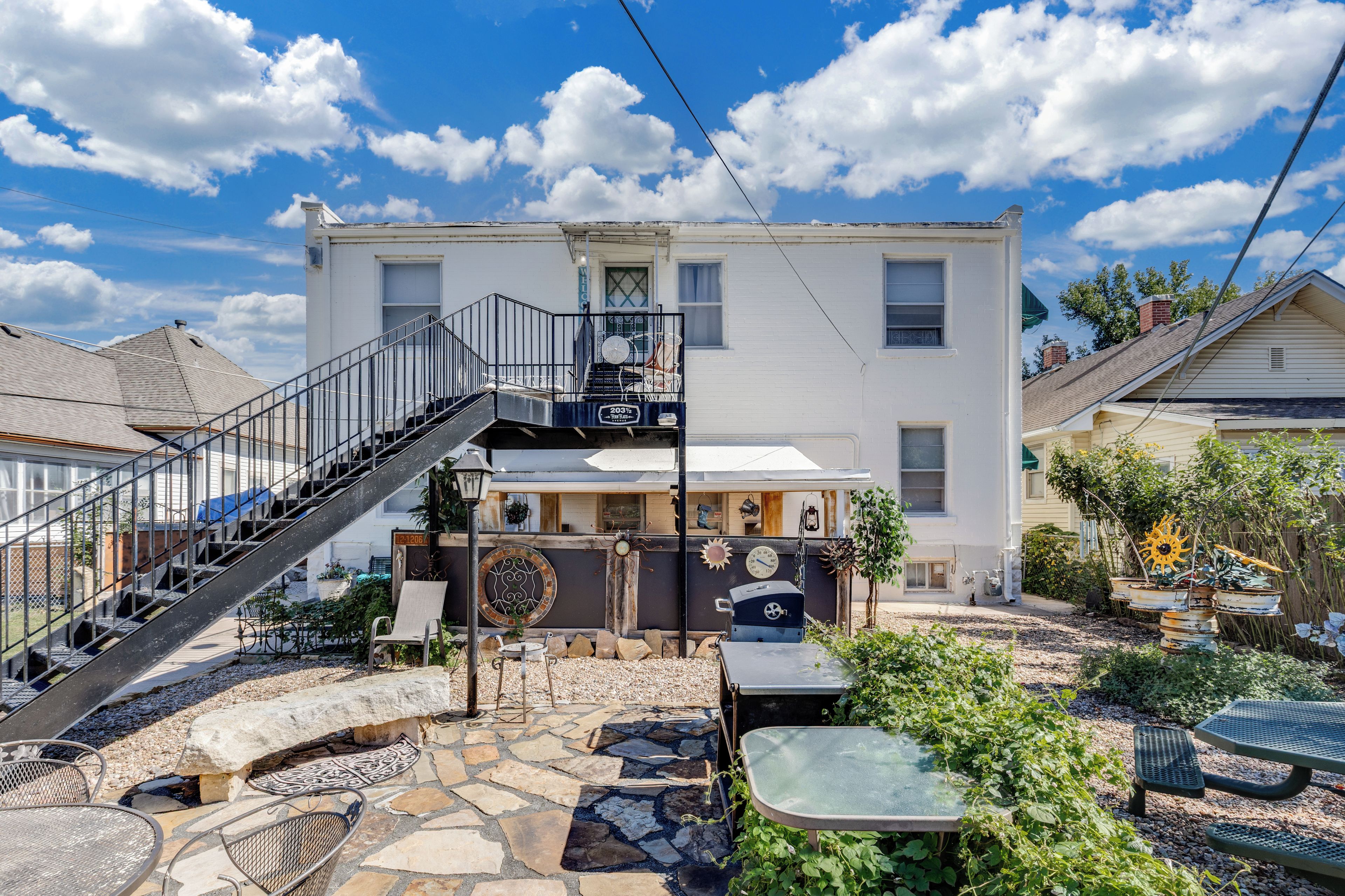 Spacious backyard patio with lounge seating and charming outdoor retreat