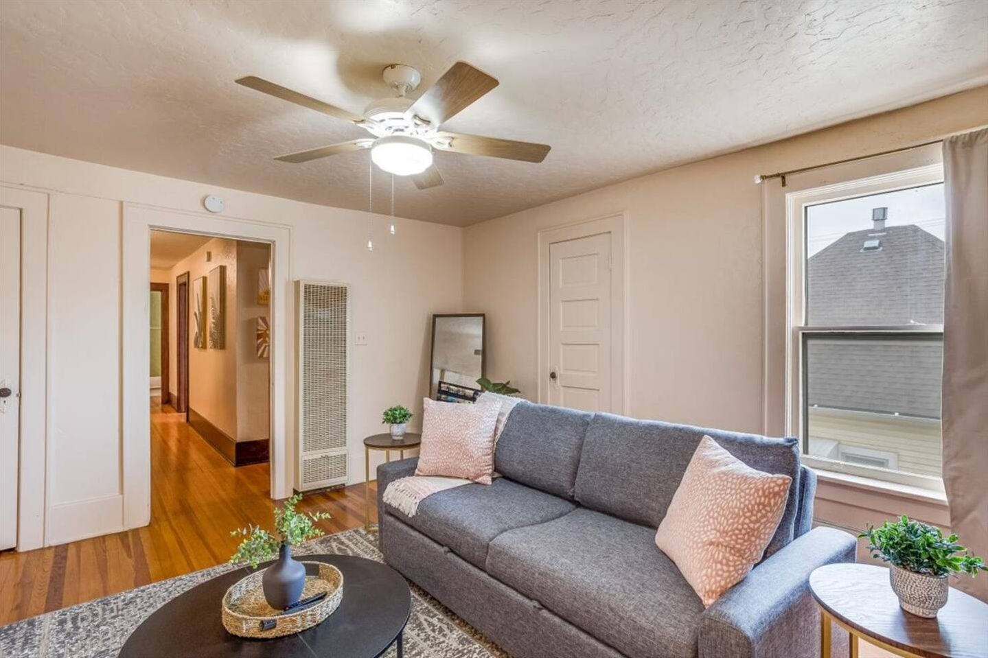 Bright, cozy living room with hardwood floors and stylish seating