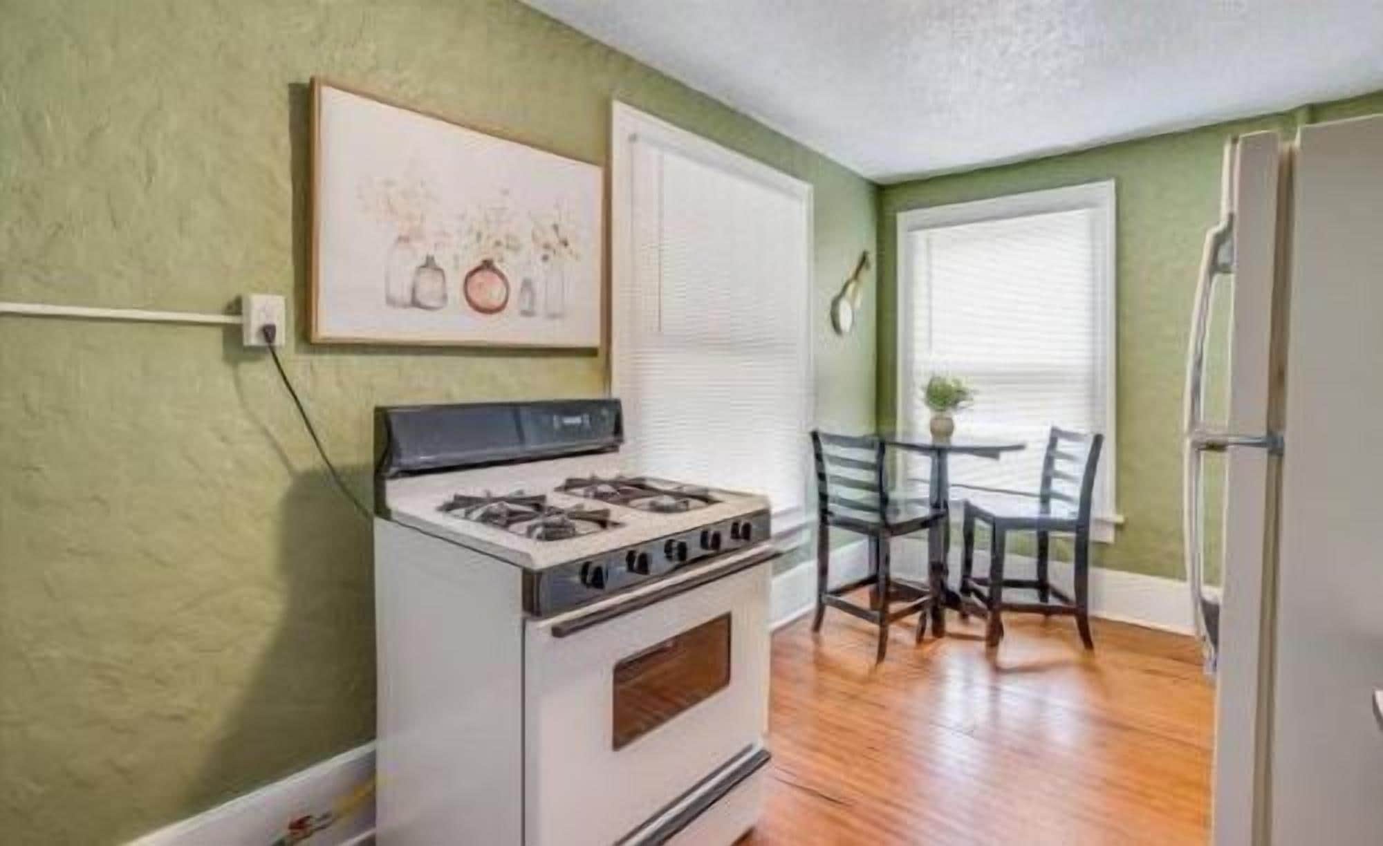 Bright kitchen with gas stove and cozy dining nook for two