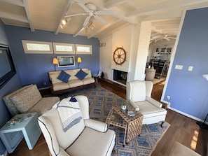 A living room with a sofa, armchairs, a coffee table, and a fireplace. - Journey by the Sea ~ Rockport, Texas (Rockport)