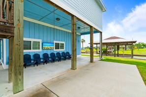 A covered outdoor seating area with chairs and a gazebo. - Salty Vibes ~ Canal Front (Rockport)