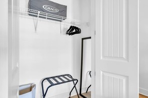 A white room with a GRACO drying rack, a black metal drying rack, and a white door. - Good Day Sunshine by Stay on 30a (Seacrest Beach)